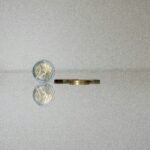 a gold ring with a gold ring with a coin on top of it