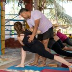 a group of people doing yoga in a room